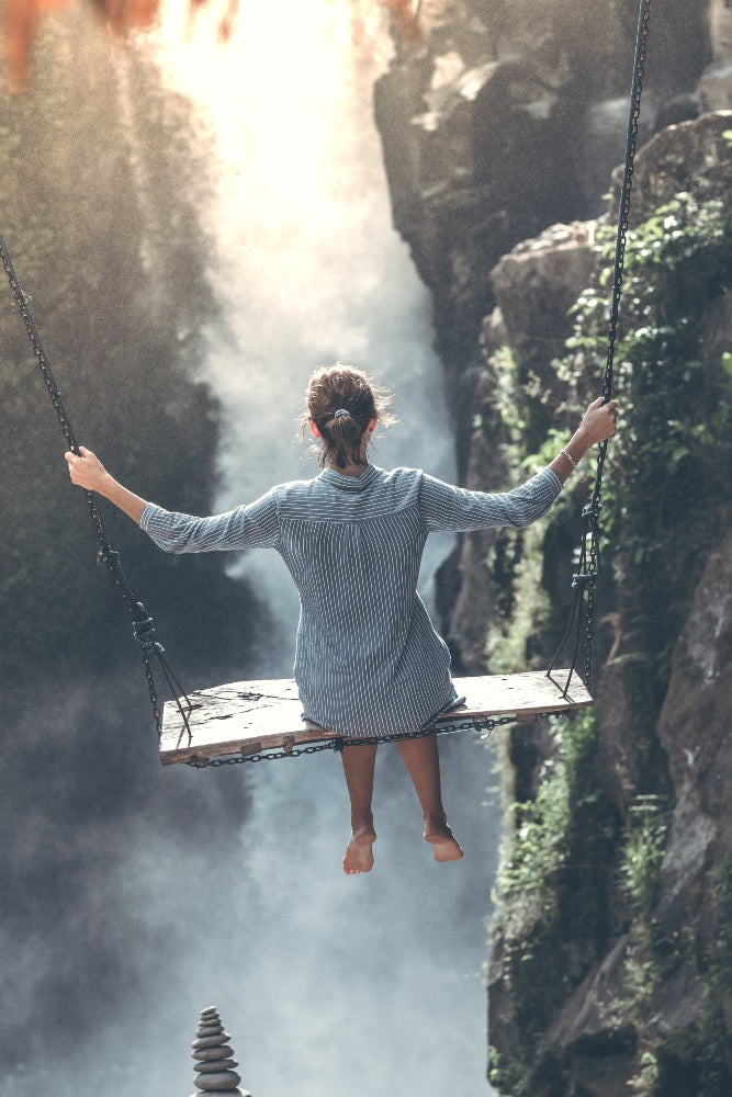 Happii Human Happy Human How to be happy woman on a swing over a waterfall